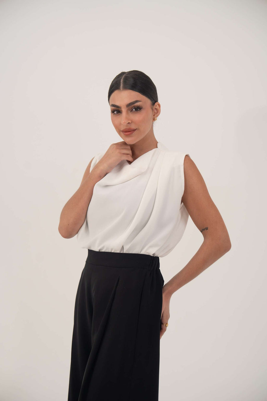 Woman wearing Crepe Classic Black Pant with wide-leg silhouette and white sleeveless top against plain background