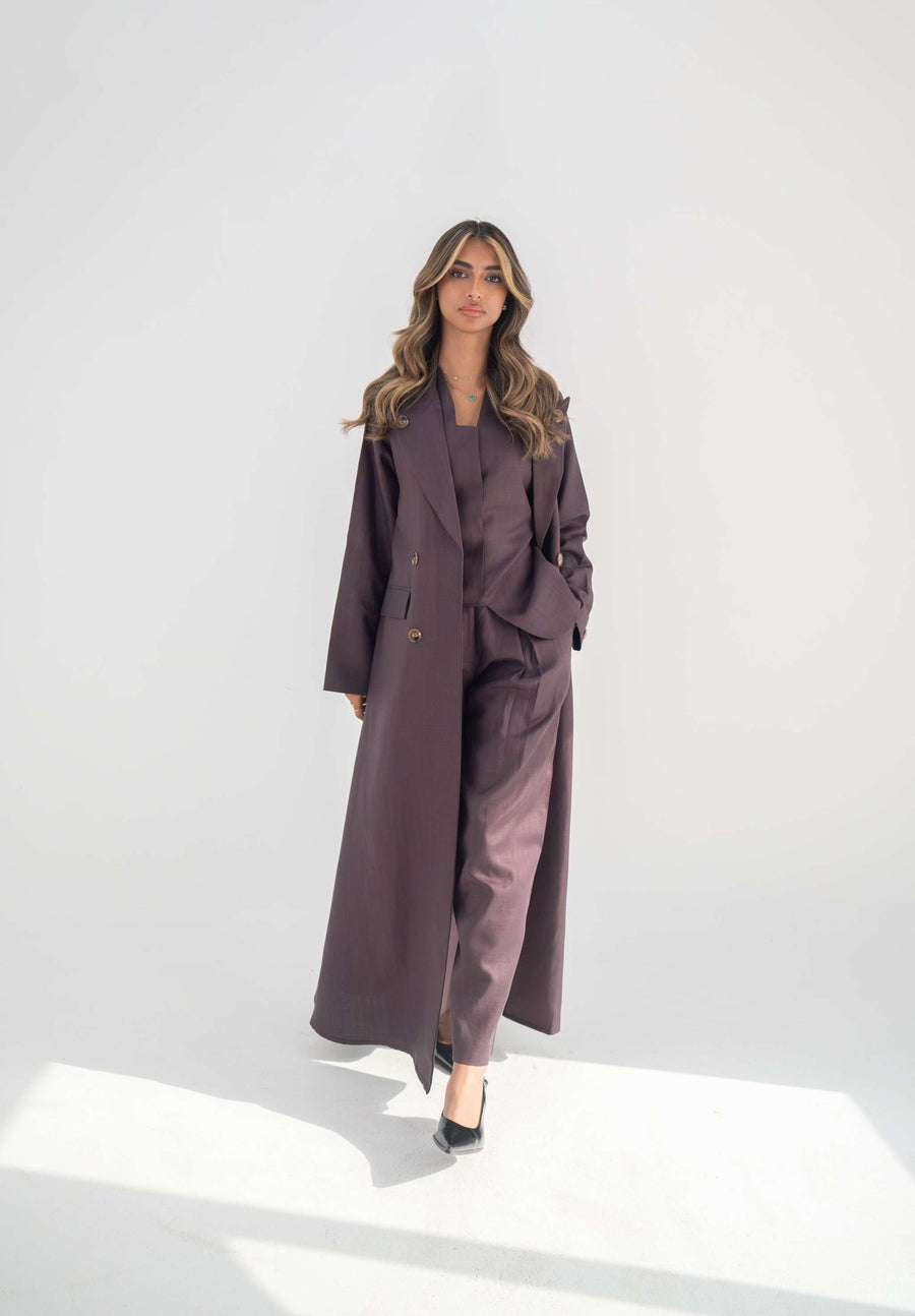 Tailored blazer abaya in soft neutral twill linen blend with structured lapels, statement buttons, and side flap pockets for elegant workwear and formal occasions.