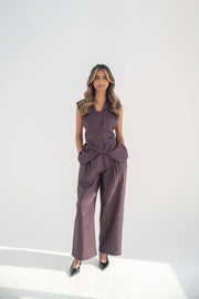Woman wearing a sleeveless Ube Vest in high-quality twill linen blend with structured cut and hidden pockets paired with matching wide-leg pants
