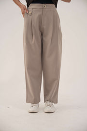Beige lightweight crepe pants with subtle pleats and relaxed fit for everyday comfort and elegant style.