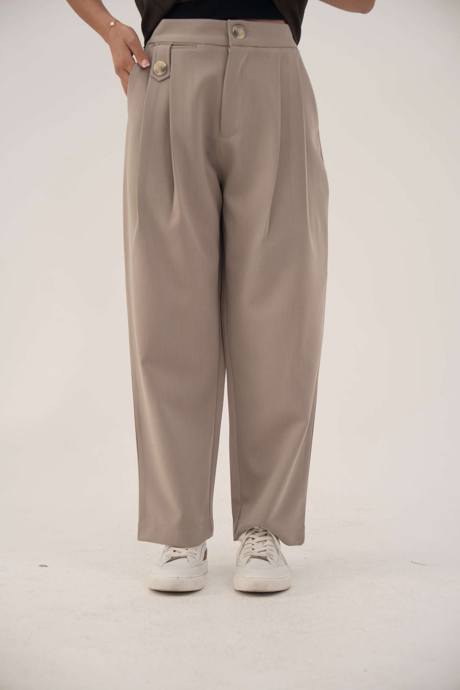 Beige lightweight crepe pants with subtle pleats and relaxed fit for everyday comfort and elegant style.