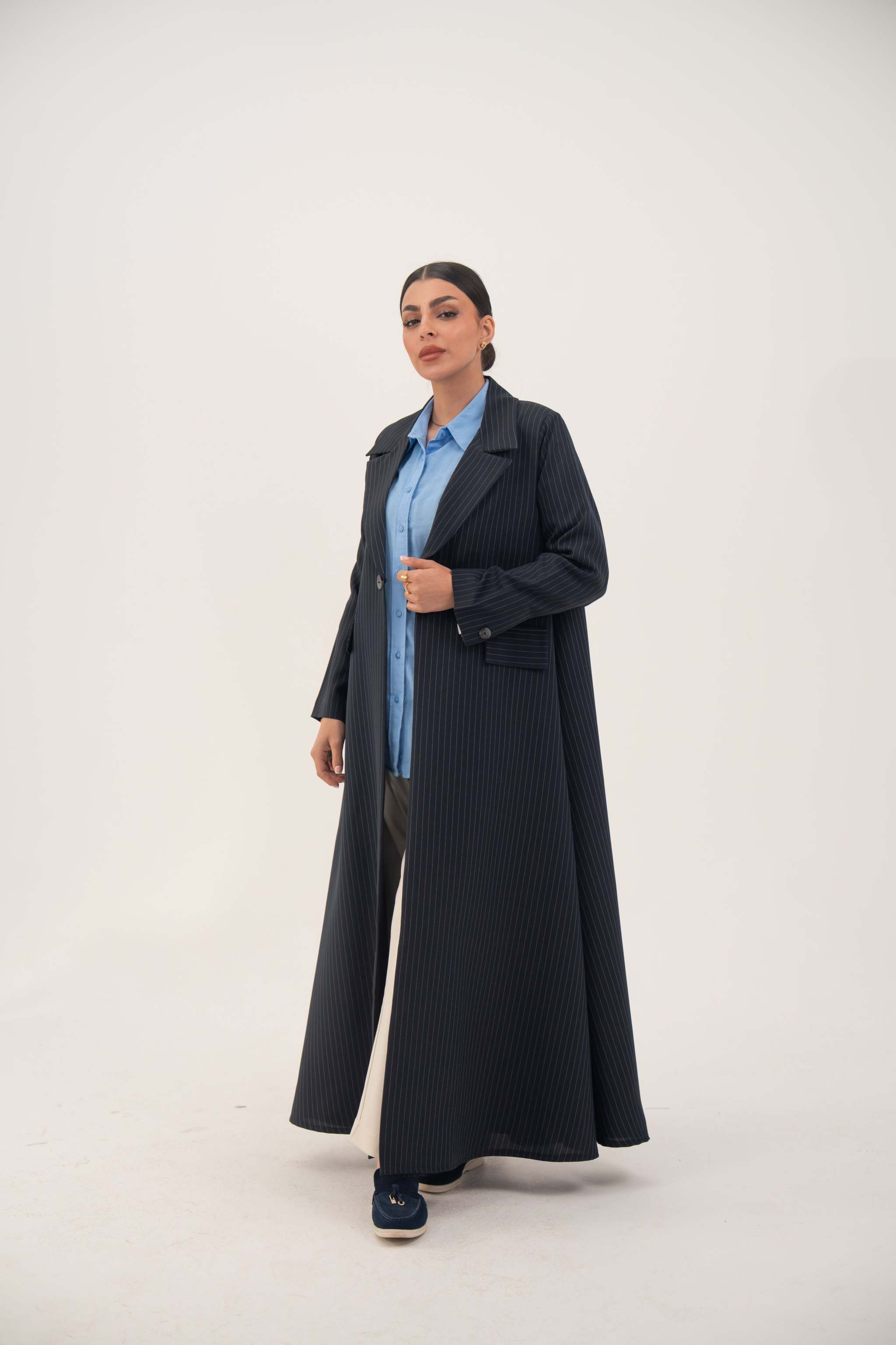 woman wearing Zanira premium navy crepe blend open-front blazer abaya with wide lapel and white pinstripes