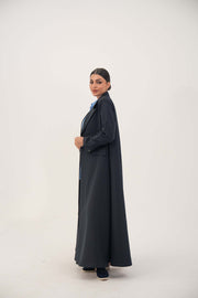 Woman wearing Zanira premium crepe blend open-front blazer abaya in deep navy with fine white pinstripes and buttoned cuffs.