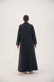 Back view of a Zanira premium crepe blend open-front blazer abaya in deep navy with fine white pinstripes, featuring wide lapels, shoulder pads, decorative pockets, inner pocket, and buttoned cuff straight sleeves.