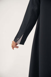 Close-up of a deep navy crepe blend blazer sleeve with fine white pinstripes and buttoned cuff from Zanira collection