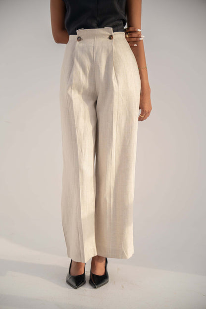 Beige high-waisted Madeleine Pants in twill linen blend with relaxed straight-leg fit and button details.