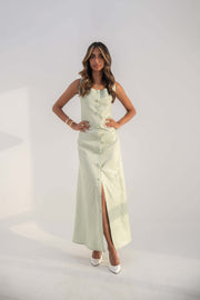 Woman wearing sleeveless mint green twill linen blend Peppermint Inner dress with front buttons and straight cut