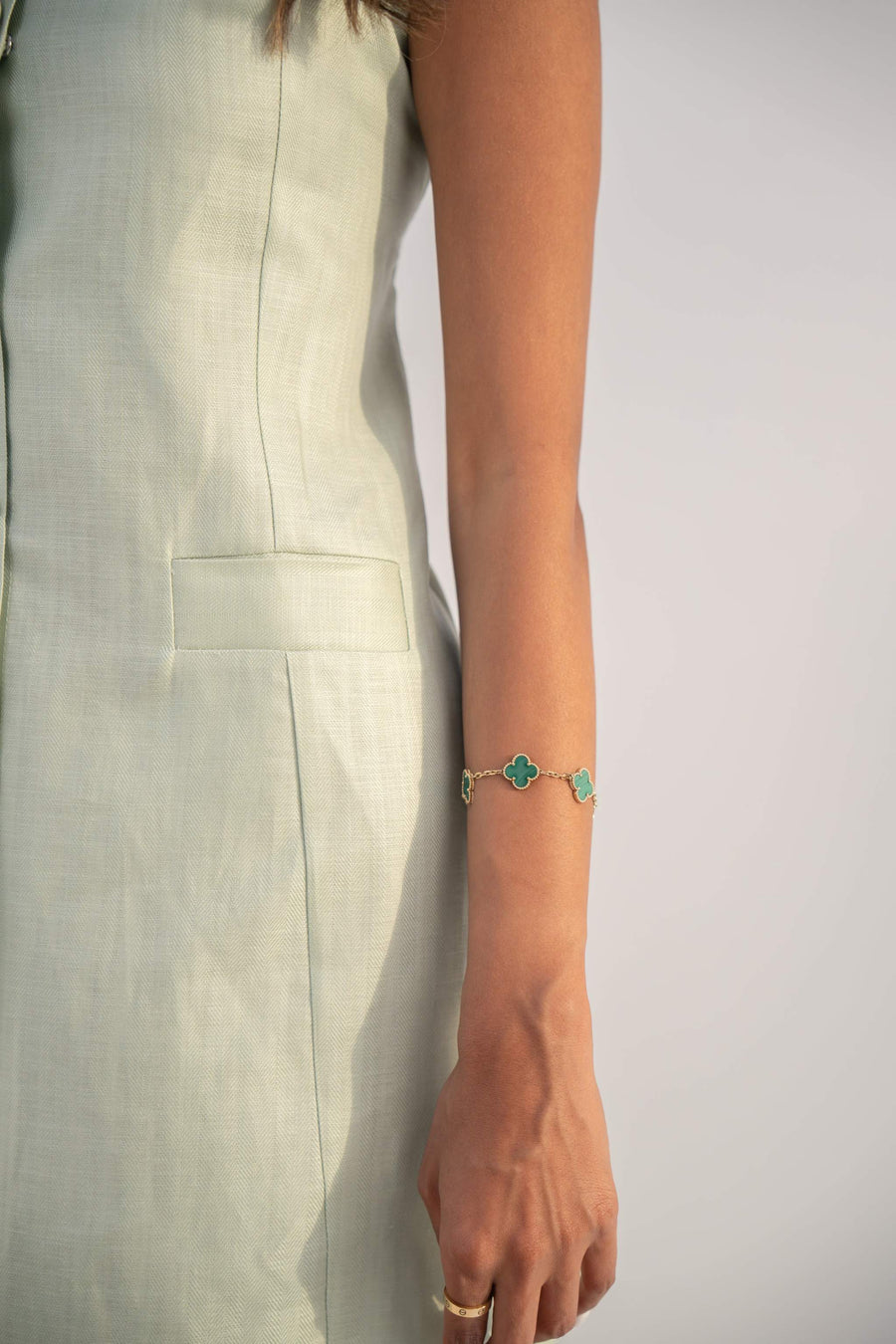 Sleeveless peppermint green inner dress in twill linen blend with front button closure and straight cut design.