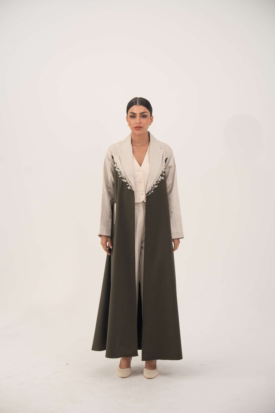 long olive green abaya with beige linen panels and white leaf embroidery on chest
