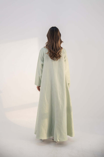 abaya crafted from soft twill linen blend in mint green with long, structured open-front design and draped collar
