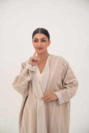 Elegant beige linen abaya with subtle tonal embroidery and soft chiffon cuffs for a light, breathable, and graceful fit