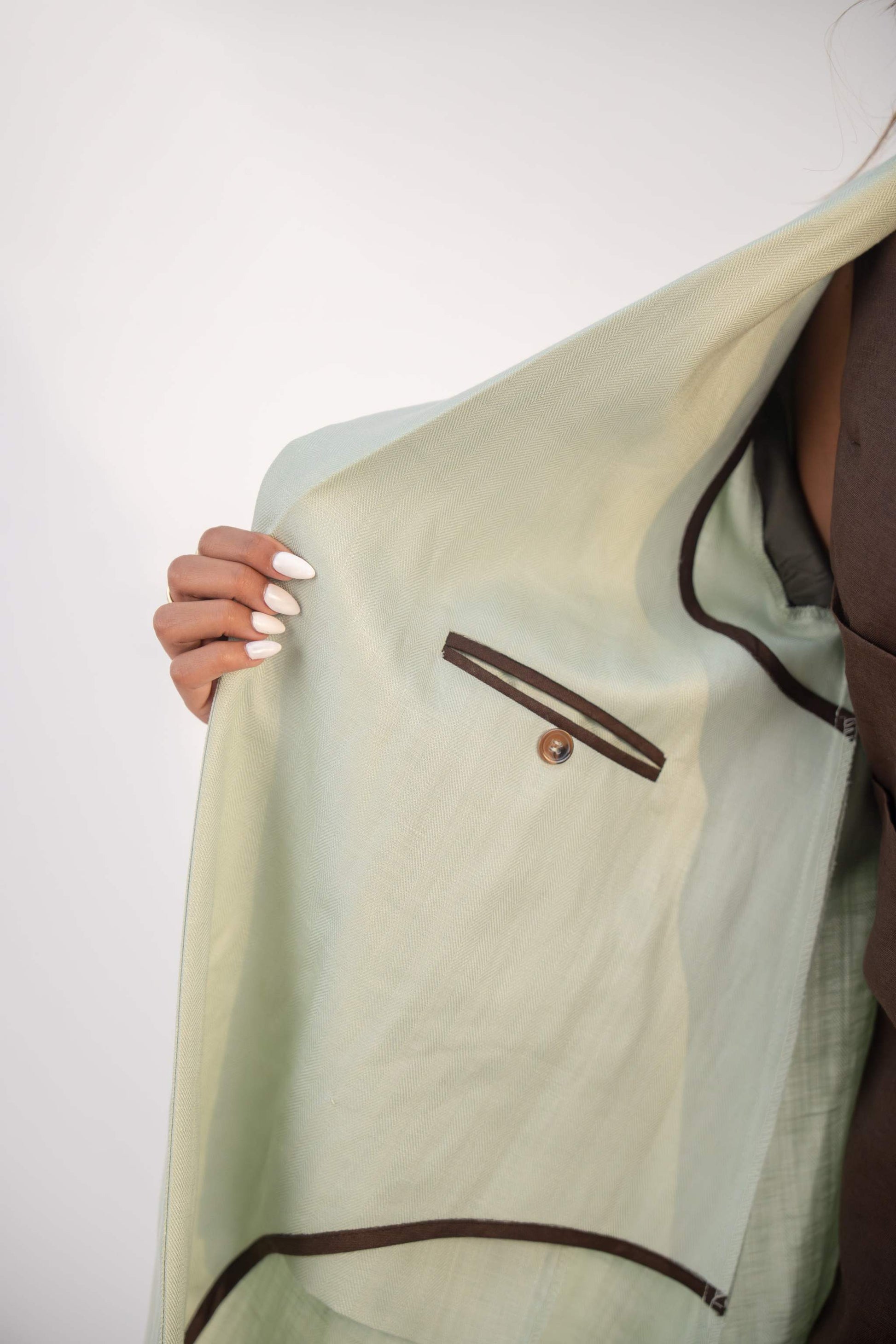 Mint fudge tailored blazer abaya in soft twill linen blend with structured lapels, statement buttons, and practical pockets.