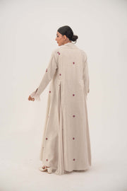 Beige linen abaya with burgundy floral embroidery and soft chiffon pleats, featuring a shawl collar and flowing design.