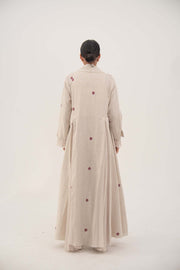 Back view of natural beige linen abaya with burgundy floral embroidery and soft chiffon pleats