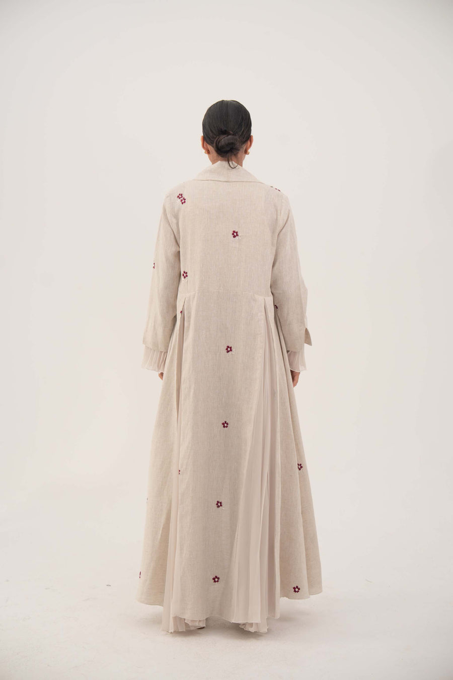 Back view of natural beige linen abaya with burgundy floral embroidery and soft chiffon pleats