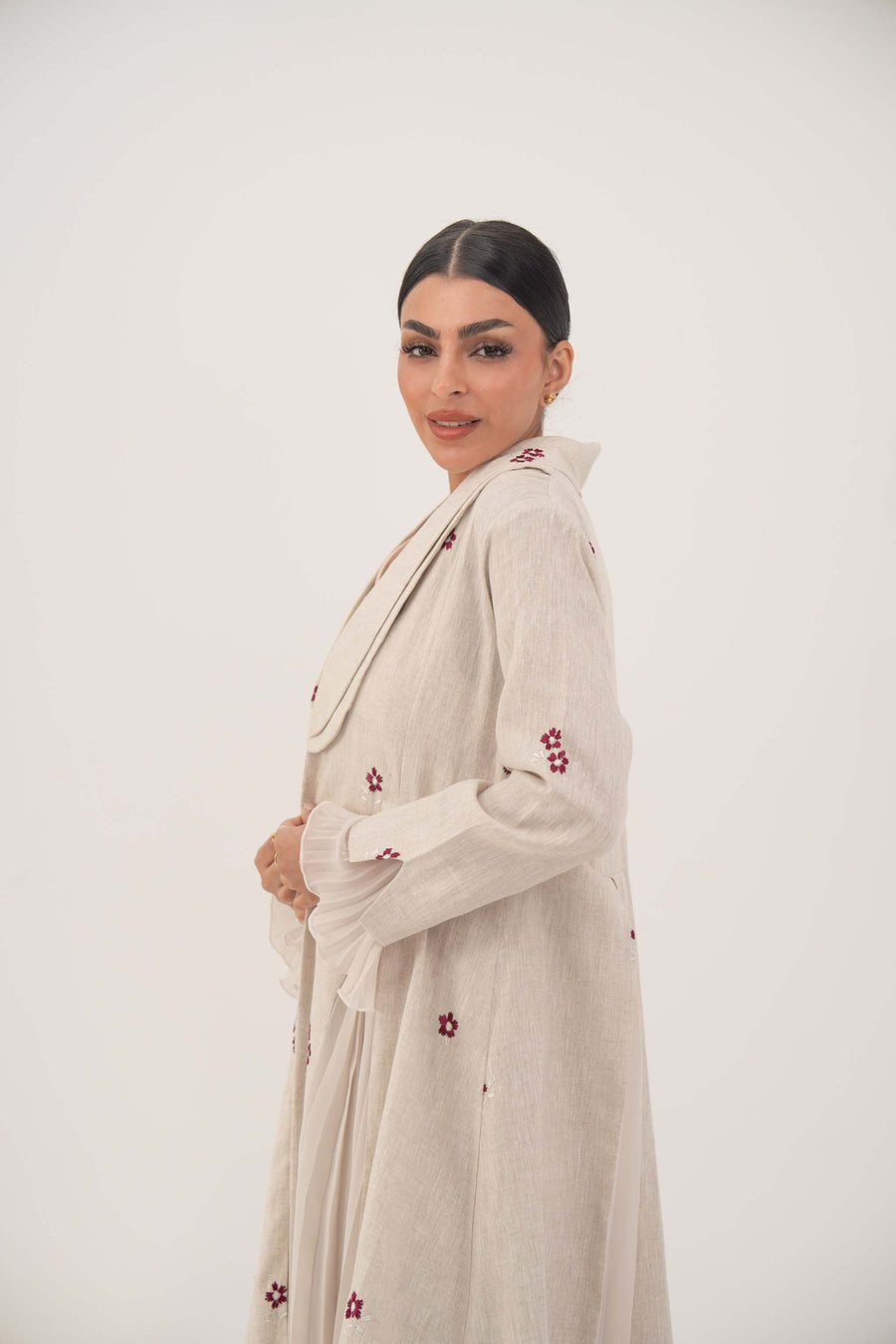 Natural beige linen abaya with burgundy floral embroidery, chiffon pleats, and shawl collar