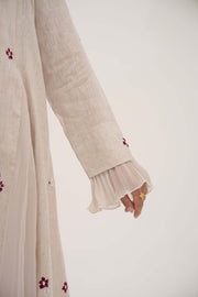 Beige linen abaya with burgundy floral embroidery and soft chiffon pleats on sleeves.
