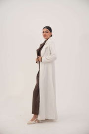 Elegant white linen abaya with grey pinstripes, blazer-inspired sharp lapel, single button, dark brown inner cuffs, and long flared hem - Elegant abaya