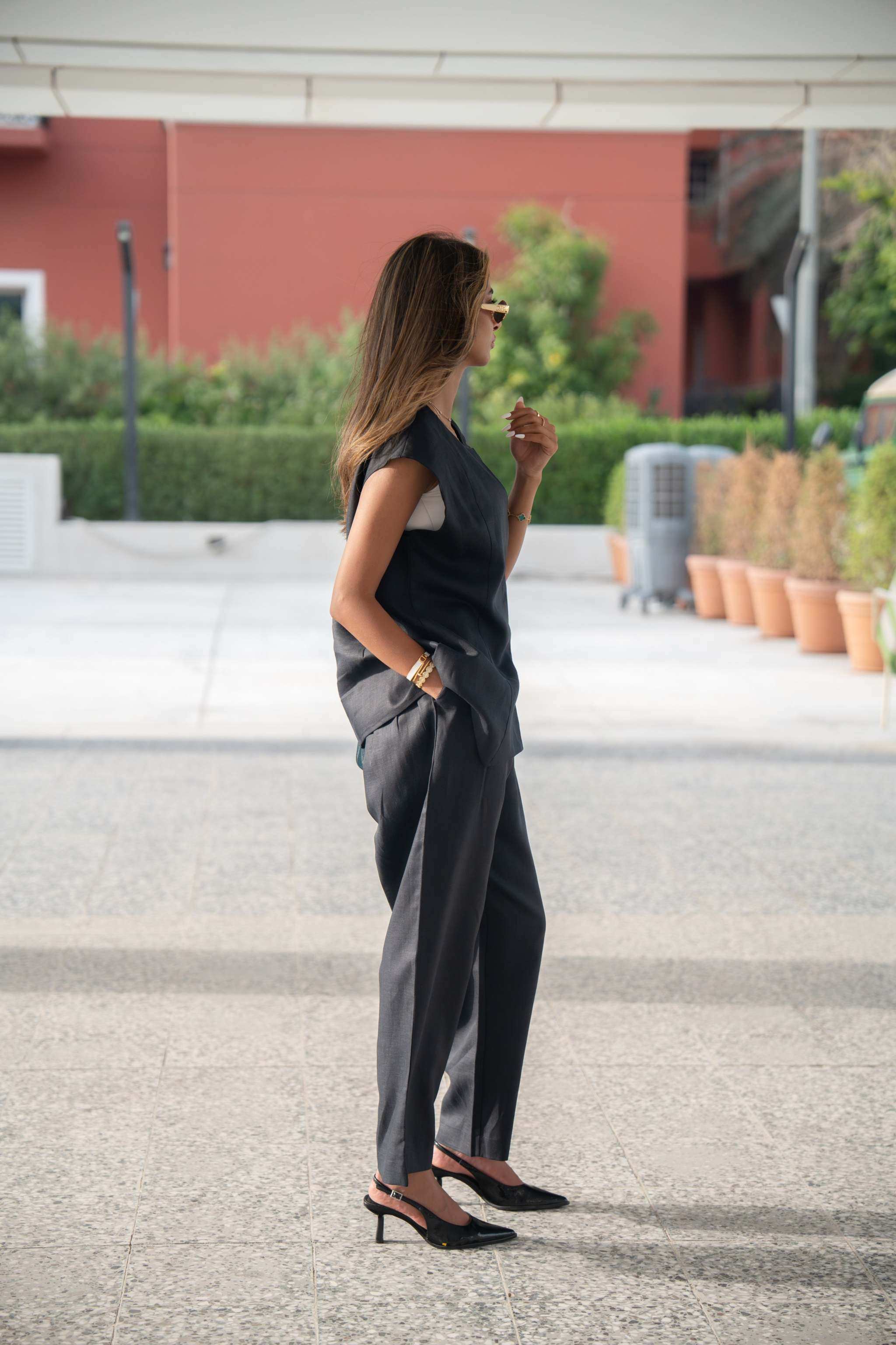 Woman wearing relaxed-fit navy blue linen pants with straight cut and clean finish outdoors