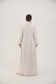 Back view of elegant white linen abaya with light grey pinstripes, dark brown inner cuffs, sharp lapel, and slightly flared long hem - Elegant abaya