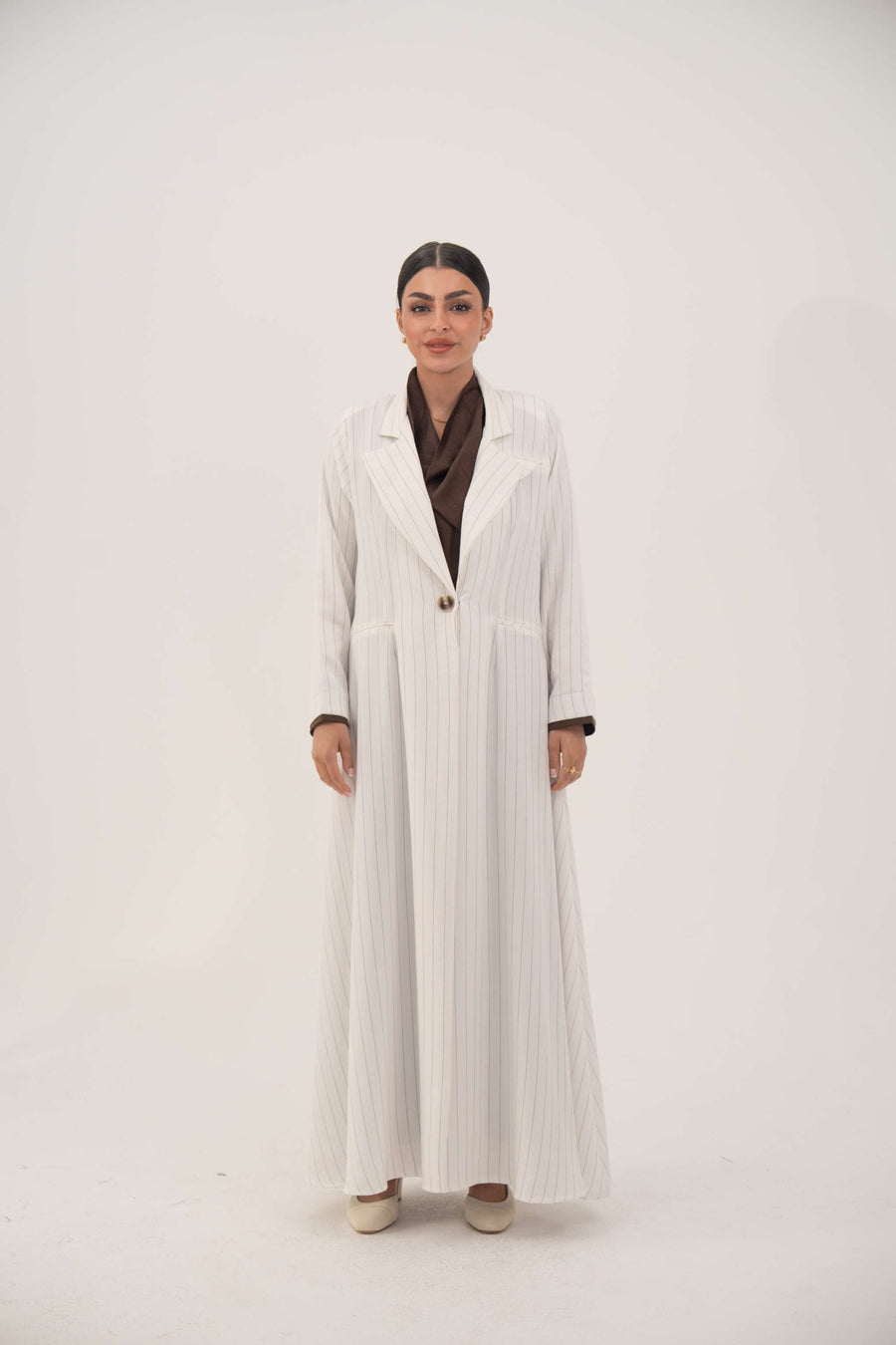 Elegant white linen abaya with soft grey pinstripes, blazer-inspired lapel, single button, and dark brown inner cuffs - Elegant abaya