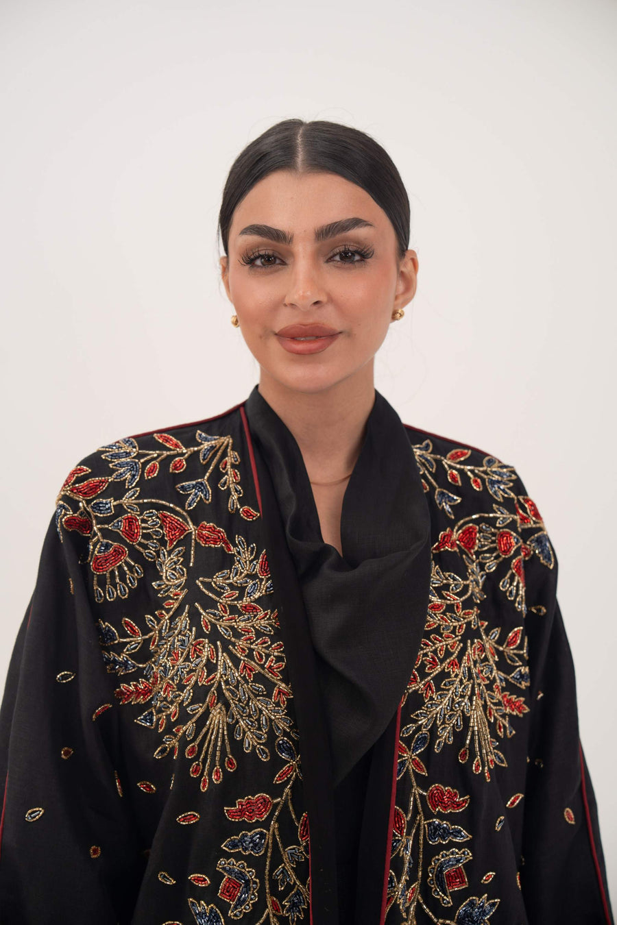 Elegant black linen abaya with multicolored red, gold, and navy embroidery and bold red trim on sleeves and shoulders - abaya crafted from premium black linen