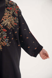 Black linen abaya with red, gold, and navy shak embroidery and red trim on sleeves and shoulders - abaya crafted from premium black linen