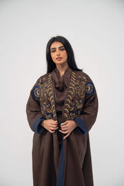 Elegant brown linen bisht abaya with navy blue chiffon lining and gold embroidery on the front.