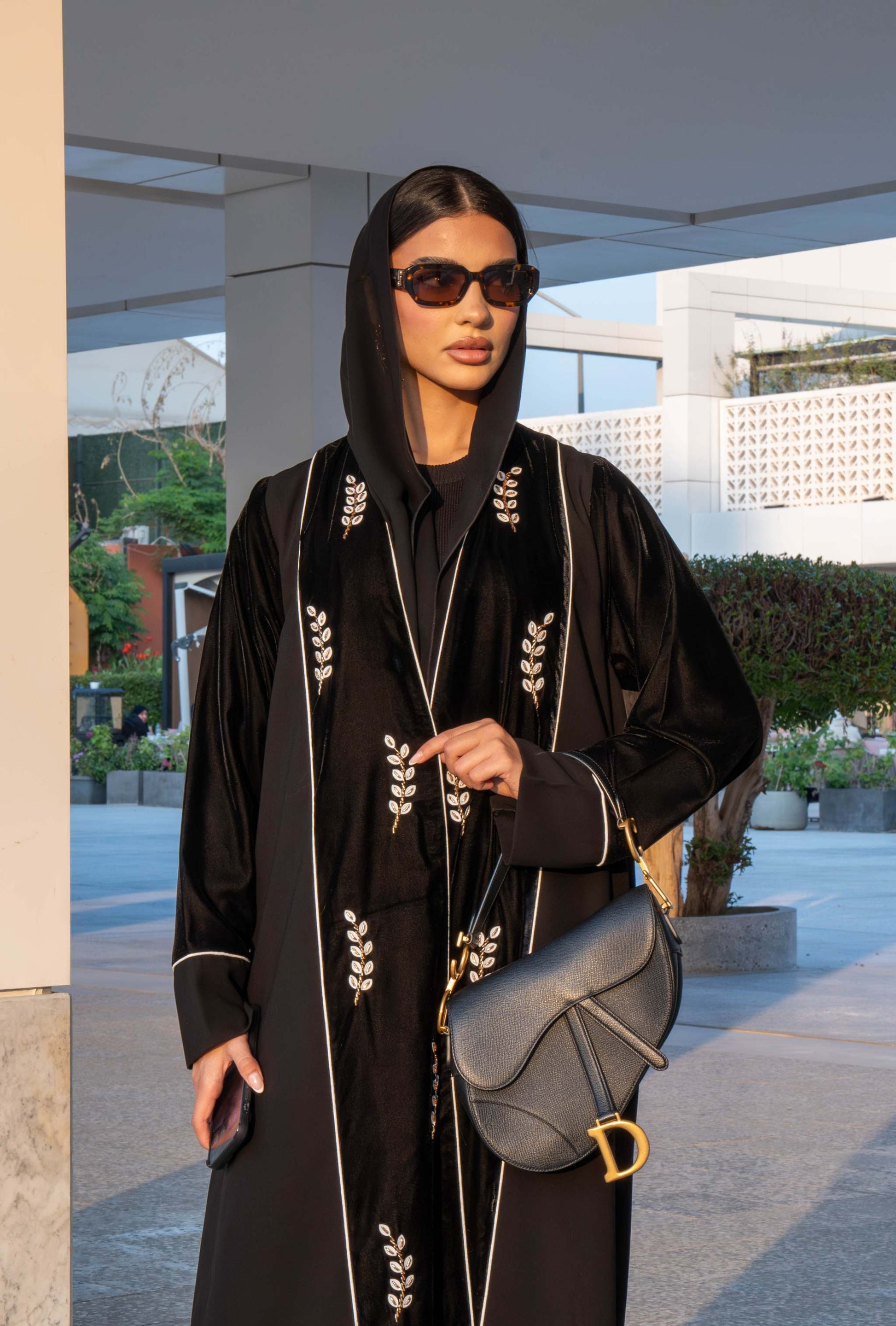Elegant black Veloura Abaya with gold embroidery and velvet accents, perfect for special occasions.
