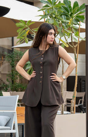 Woman wearing stylish crepe brown pant and matching sleeveless top outdoors