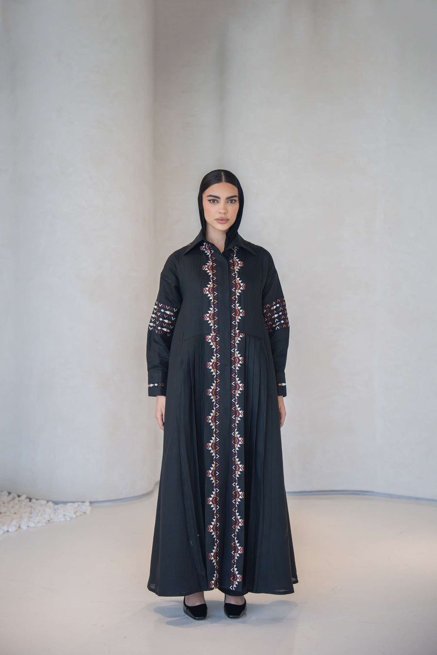 Woman wearing black Full-Length Cotton Abaya with multicolor traditional embroidery on front, sleeves, shoulders, and back.