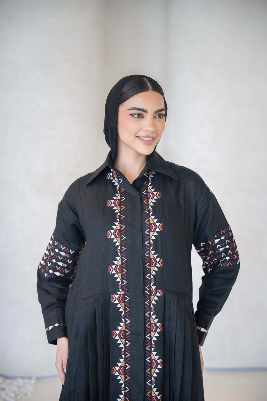 Black full-length cotton abaya with multicolor traditional-inspired embroidery on front, sleeves, shoulders, and back.