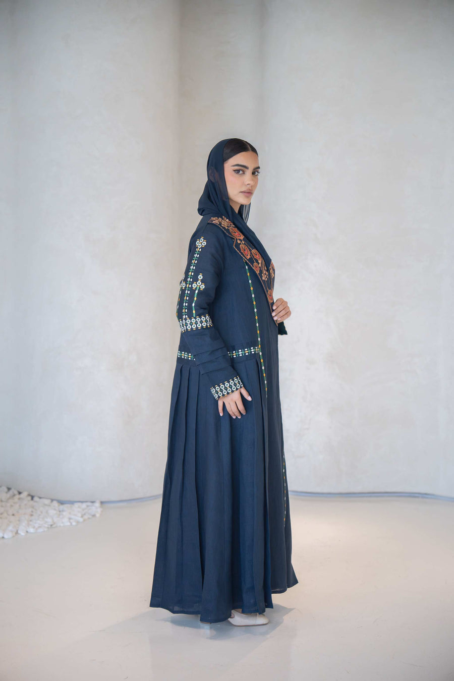 Navy blue breathable lightweight linen abaya with intricate multicolor floral hand-embroidery and a structured notched lapel collar.