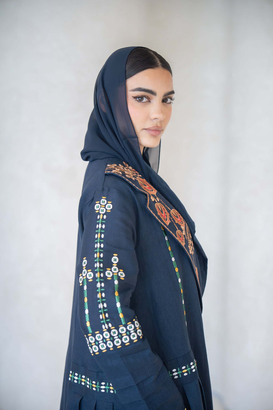 Navy blue breathable lightweight linen abaya with intricate multicolor floral embroidery on lapel, sleeves, and cuffs.