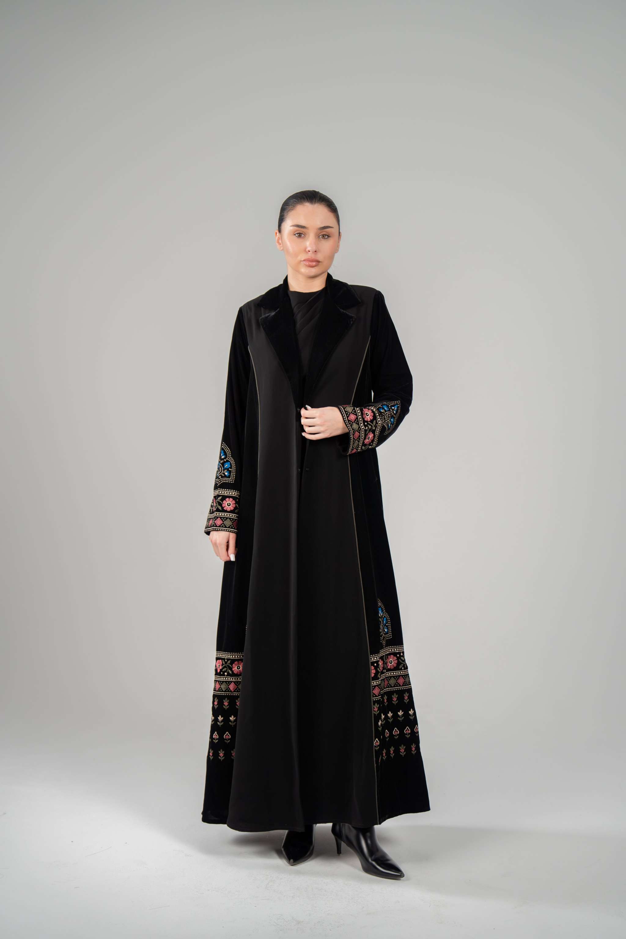Elegant black Lumin Abaya with velvet lapels and colorful machine embroidery on sleeves and hem.