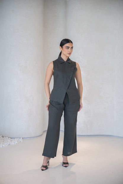 Woman wearing dark gray high-waisted wide-leg Gray Pant with sleeveless matching top and black heels in minimalist setting