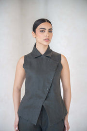 Woman wearing charcoal gray vest with asymmetrical buttoned front and shirt collar.