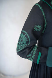 Black Zamurd abaya with green geometric embroidery on sleeves and shoulders, lightweight linen fabric with soft chiffon lining.