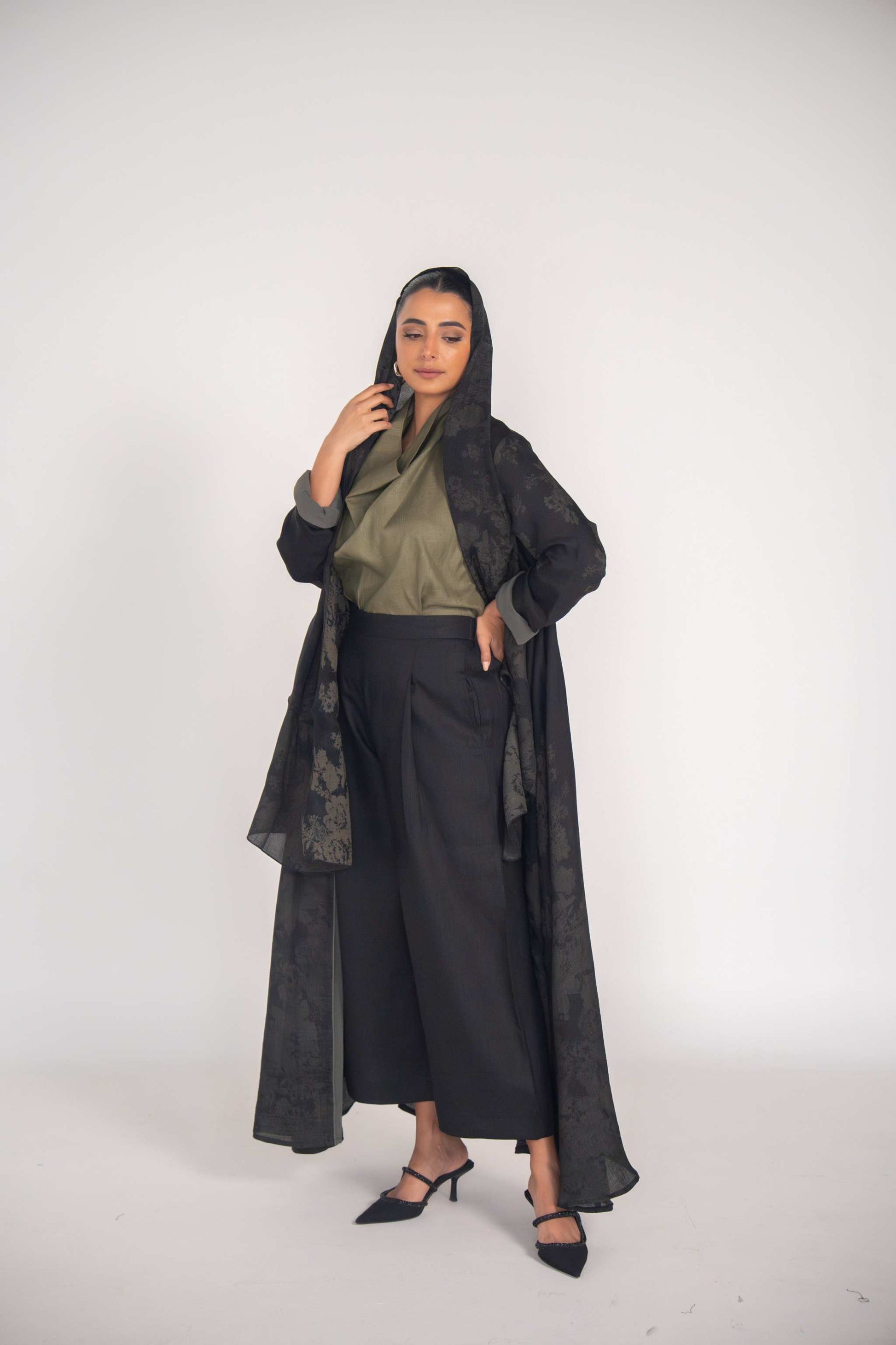 woman wearing elegant black jacquard abaya with tonal grey cuffs and soft chiffon lining, styled for modern modest fashion