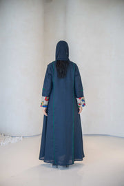 Back view of a deep navy linen abaya with emerald green piping and multicolor embroidered cuffs, featuring a modern open-front design.
