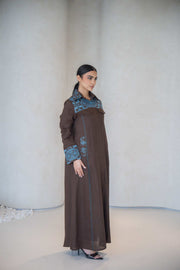 Elegant brown abaya with vertical turquoise embroidery and faux flap pocket, made from lightweight soft fabric, perfect for daily wear and special occasions abaya in a calm brown
