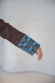 Brown abaya sleeve with intricate vertical turquoise blue embroidery and folded faux pocket detail abaya in a calm brown