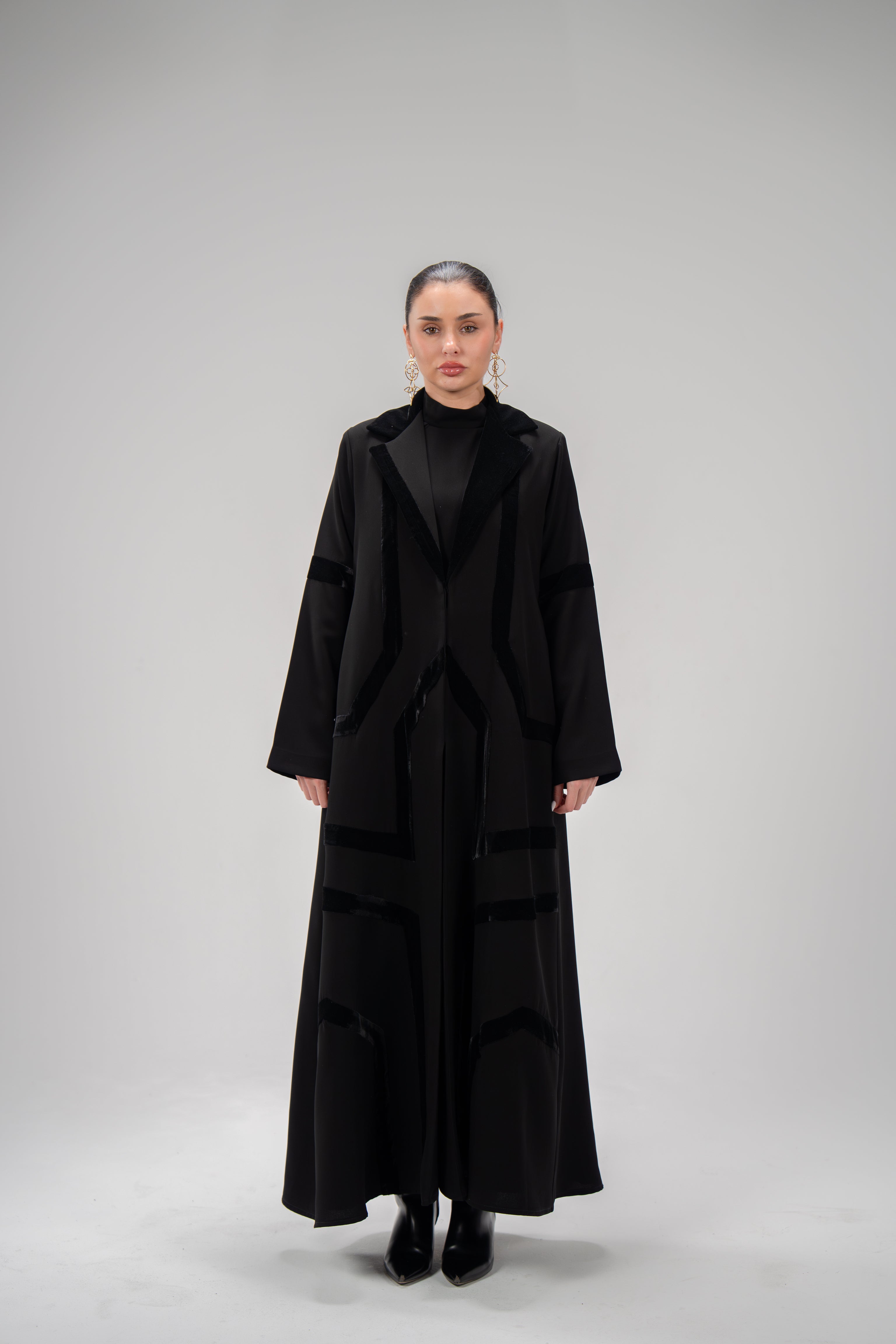 woman wearing black refined abaya with velvet detailing and silk lining