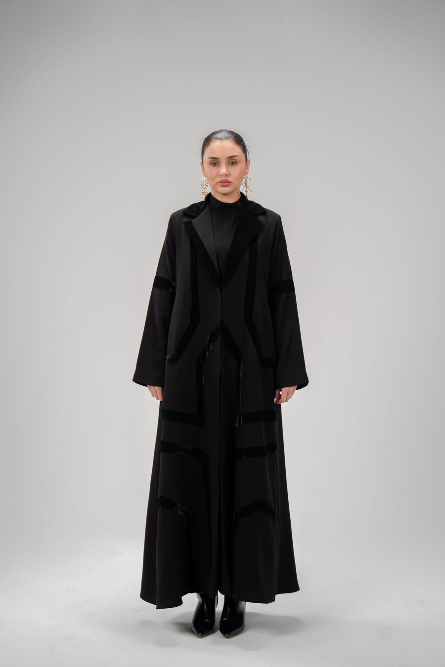 woman wearing black refined abaya with velvet detailing and silk lining