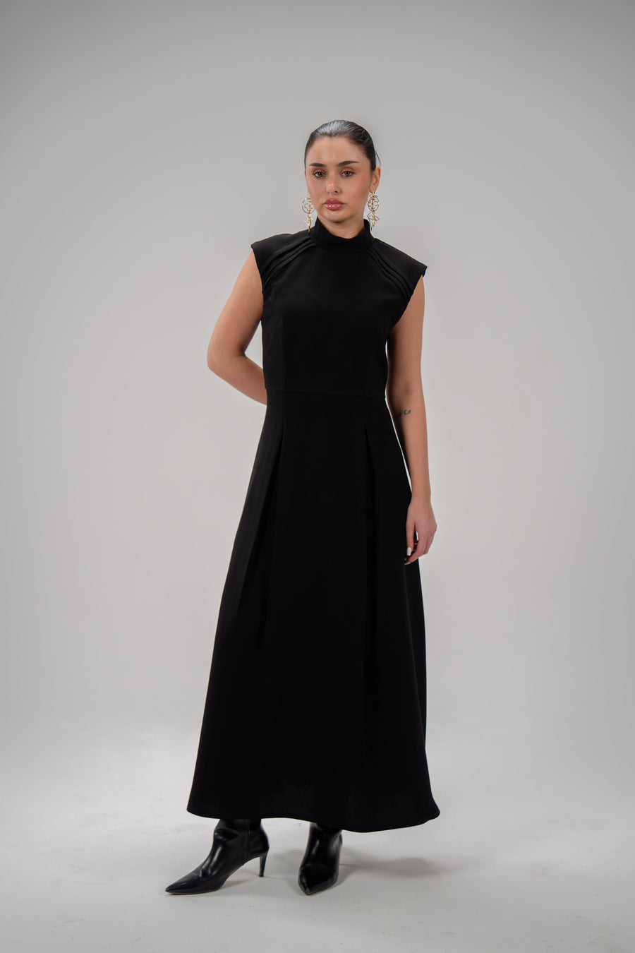 Elegant black crepe dress with pleated sleeves, soft fabric, and modest style for everyday and special occasions.
