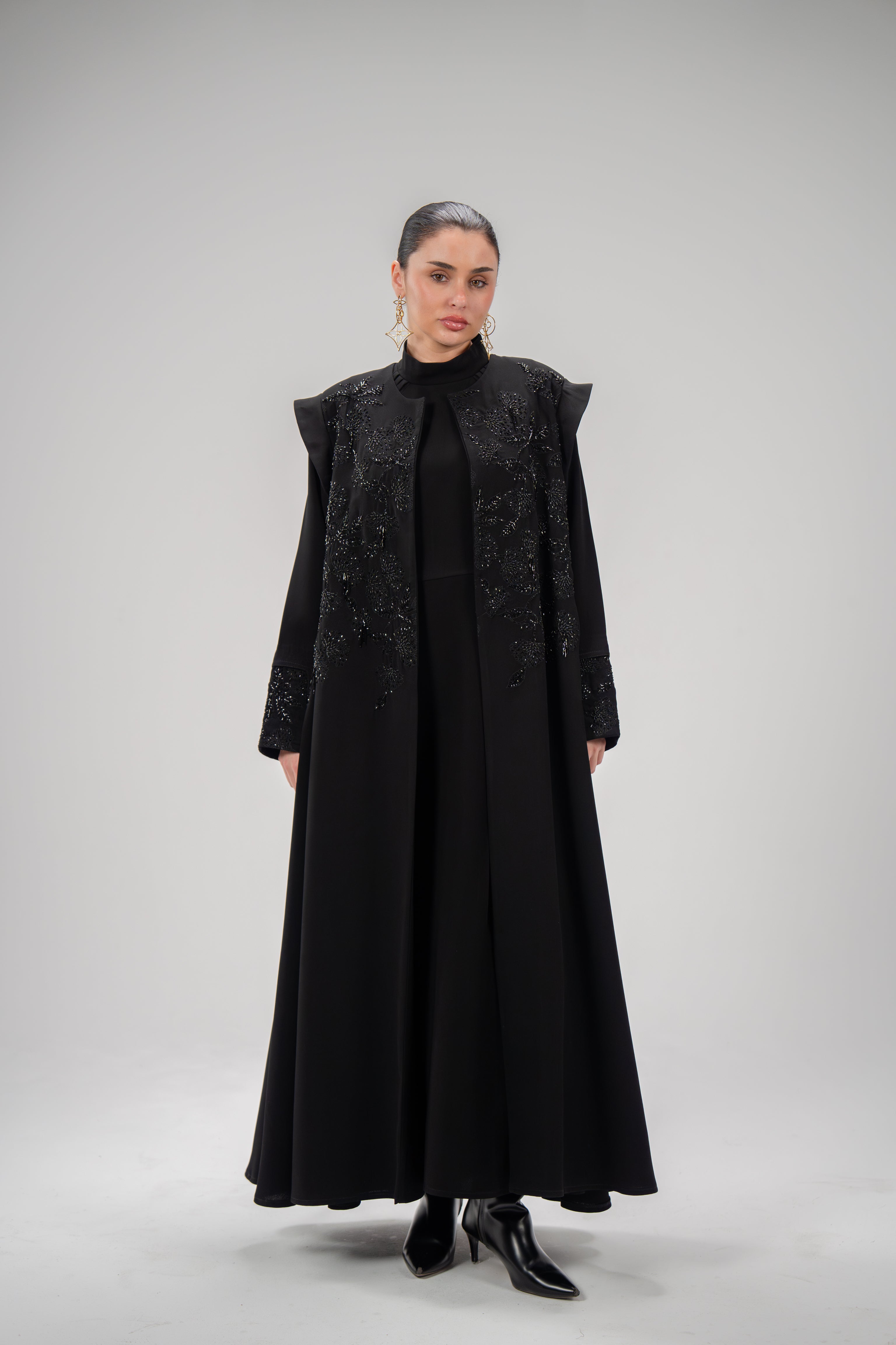 Elegant Empress Abaya in black crepe with intricate hand embroidery and beadwork on bodice and shoulders.