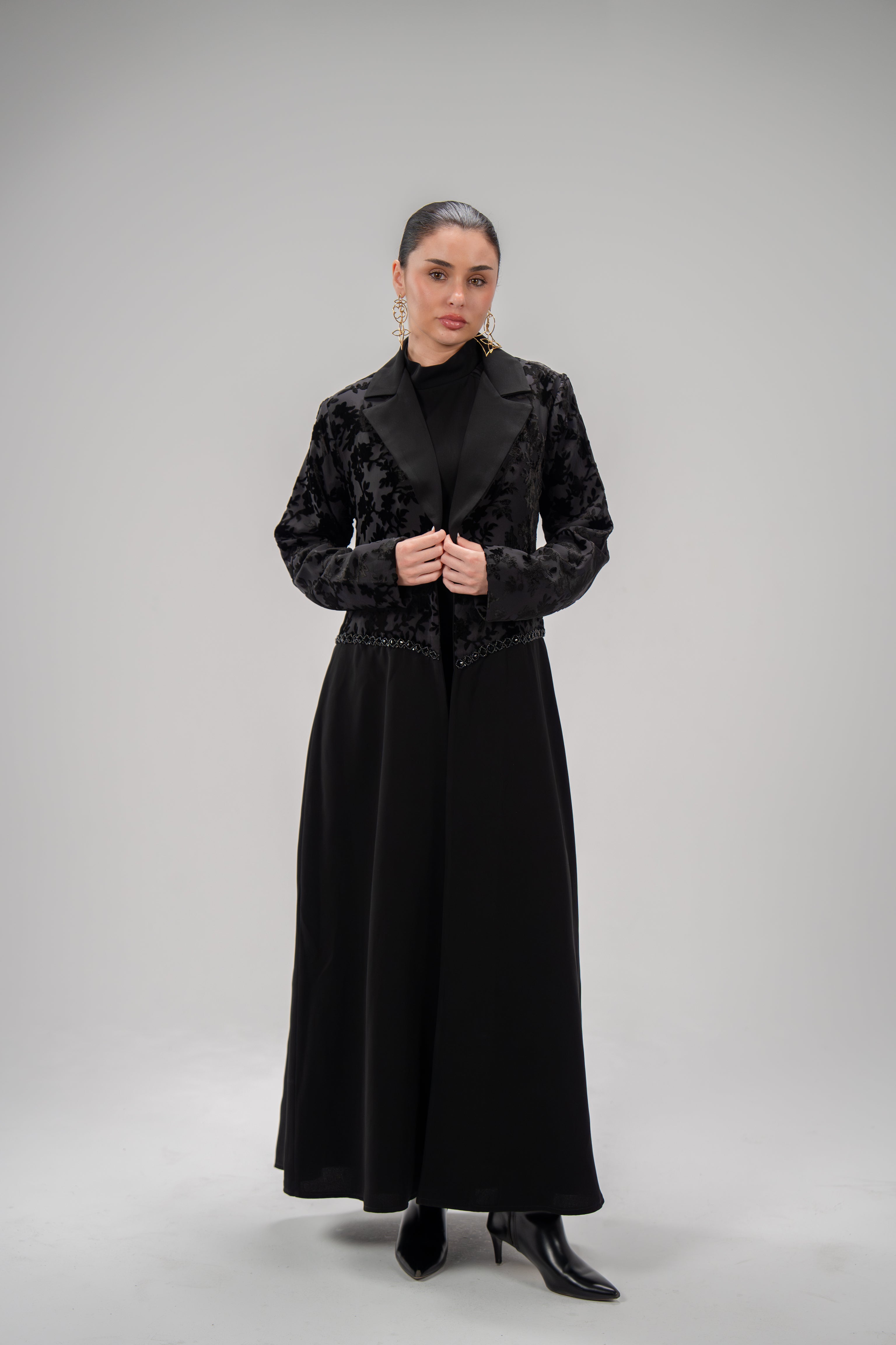 Black long dress with layering design featuring chiffon and patterned velvet top and smooth crepe bottom with hand embroidery.