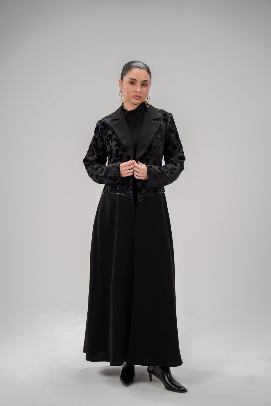 Black long dress with layering design featuring chiffon and patterned velvet top and smooth crepe bottom with hand embroidery.