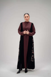 woman wearing Dahlia deep black velvet and burgundy crepe abaya with floral velvet imprint and chiffon lining