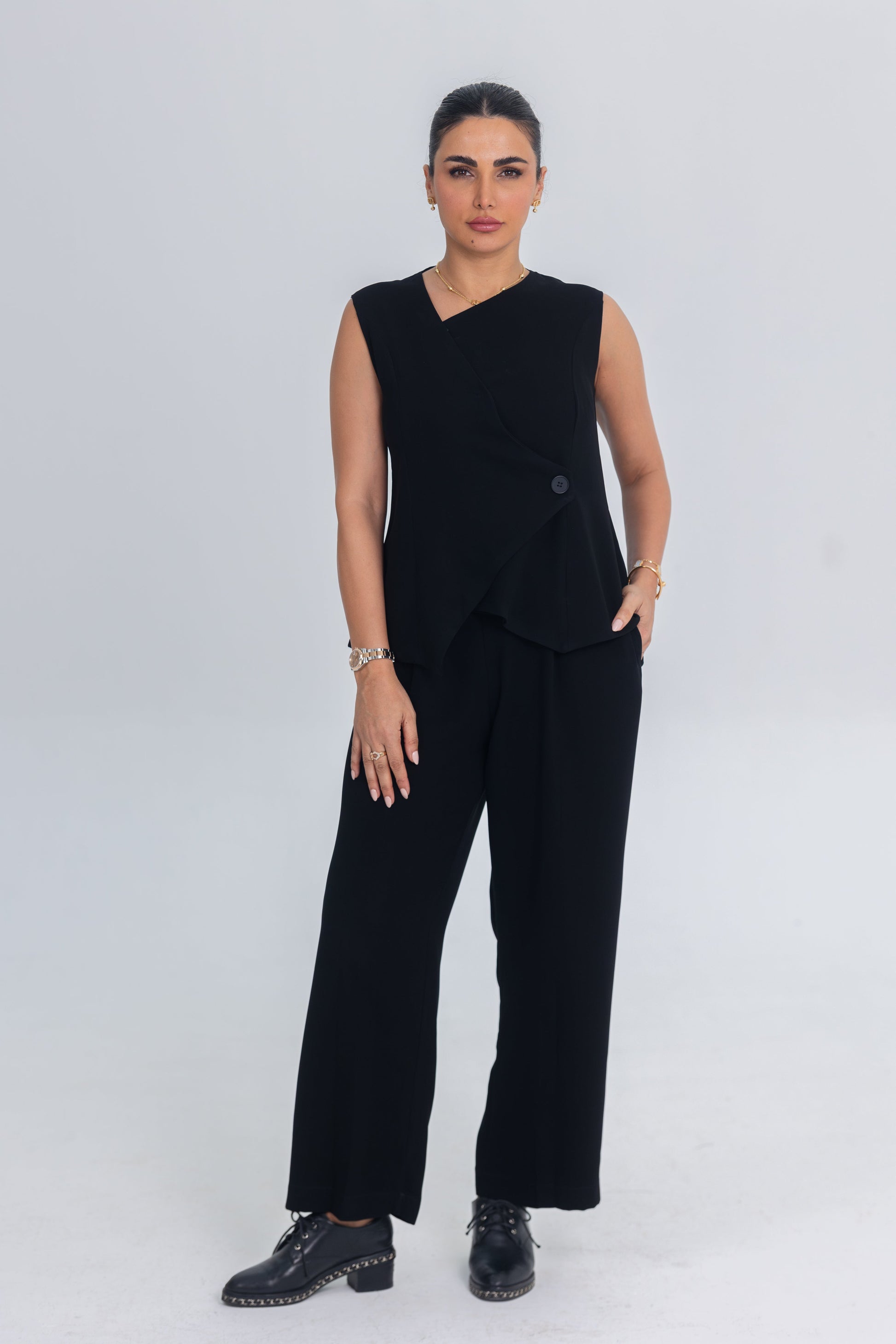 Black asymmetrical inner set with layered top and straight-cut trousers made from premium crepe fabric